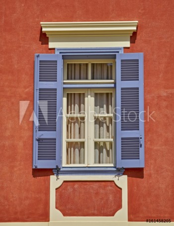Picture of elegant vintage window on orange house wall